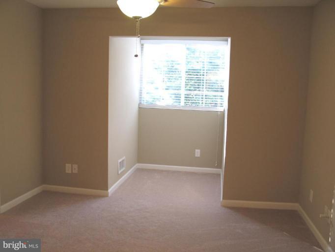 4932 Columbia Road, Unit 7 Columbia, MD 21044 - Photo 9 of 19 an empty room with windows