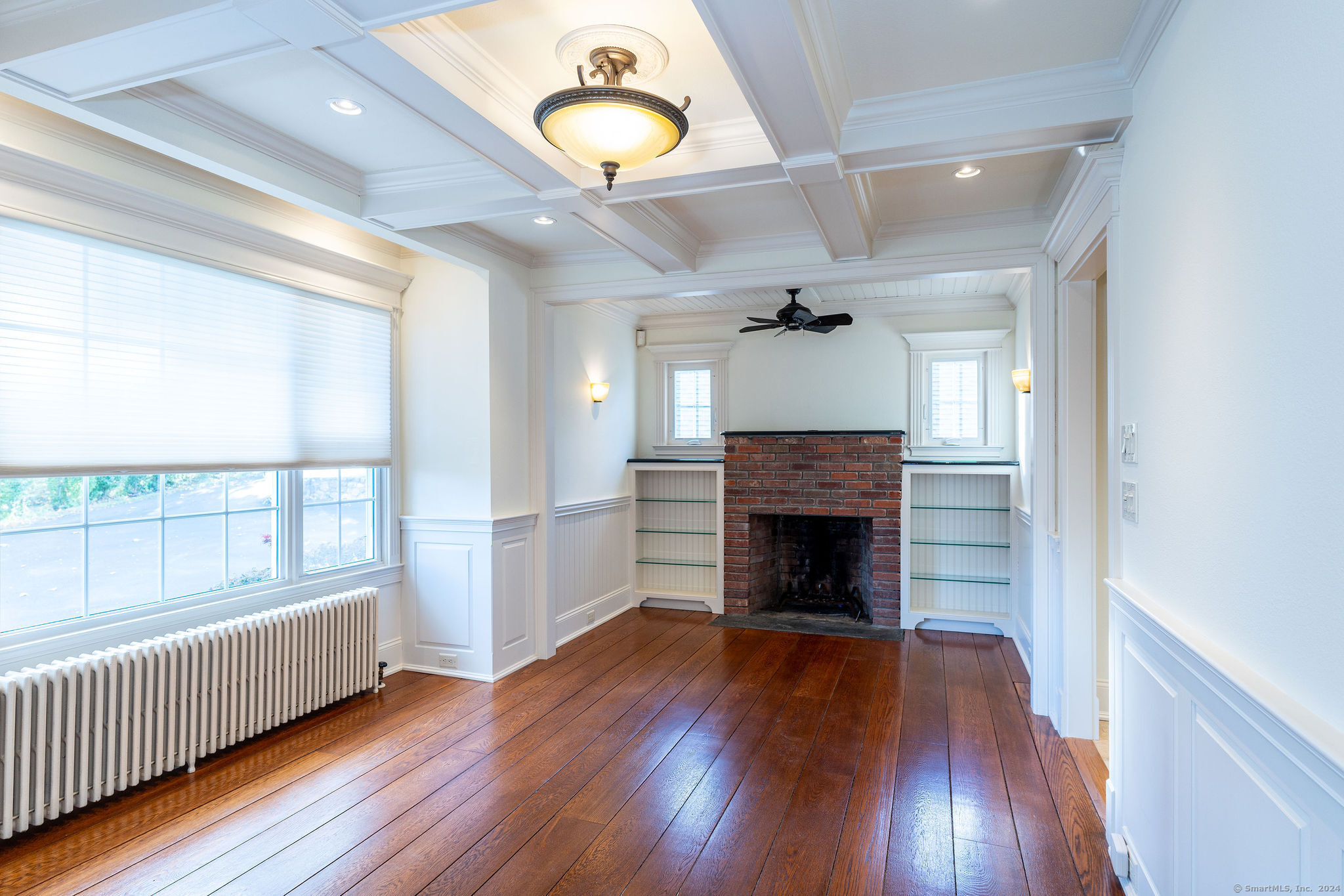 231 Buckingham Street Watertown, CT 06779 - Photo 13 of 30 an empty room with wooden floor fireplace and windows