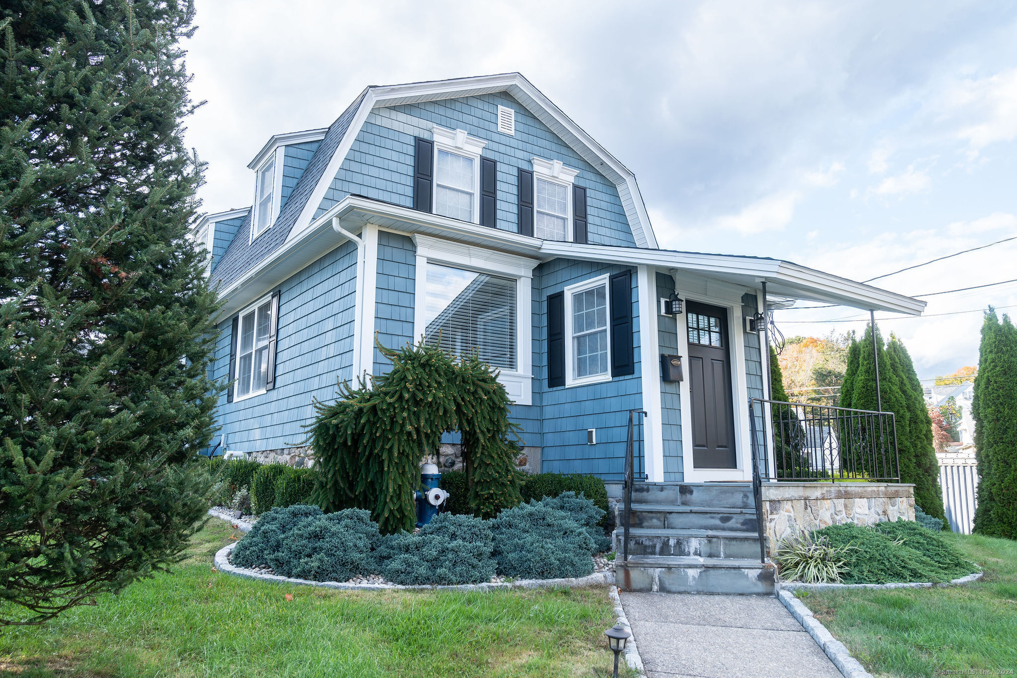231 Buckingham Street Watertown, CT 06779 - Photo 2 of 30 a front view of a house with porch and garden