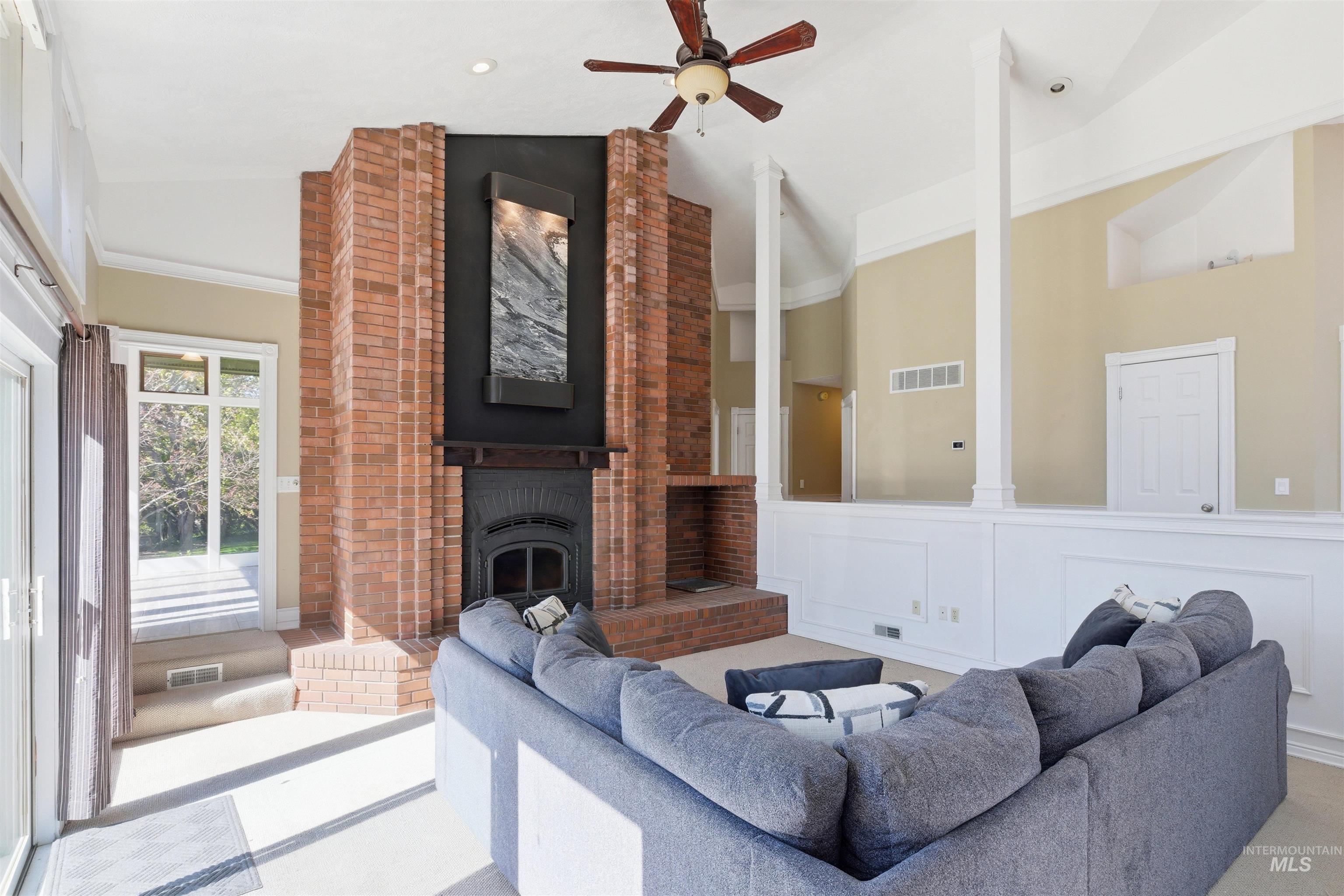 1540 Pine Cone Road Moscow, ID 83843 - Photo 12 of 49 Brick fireplace with a dark wood mantel and metal insert