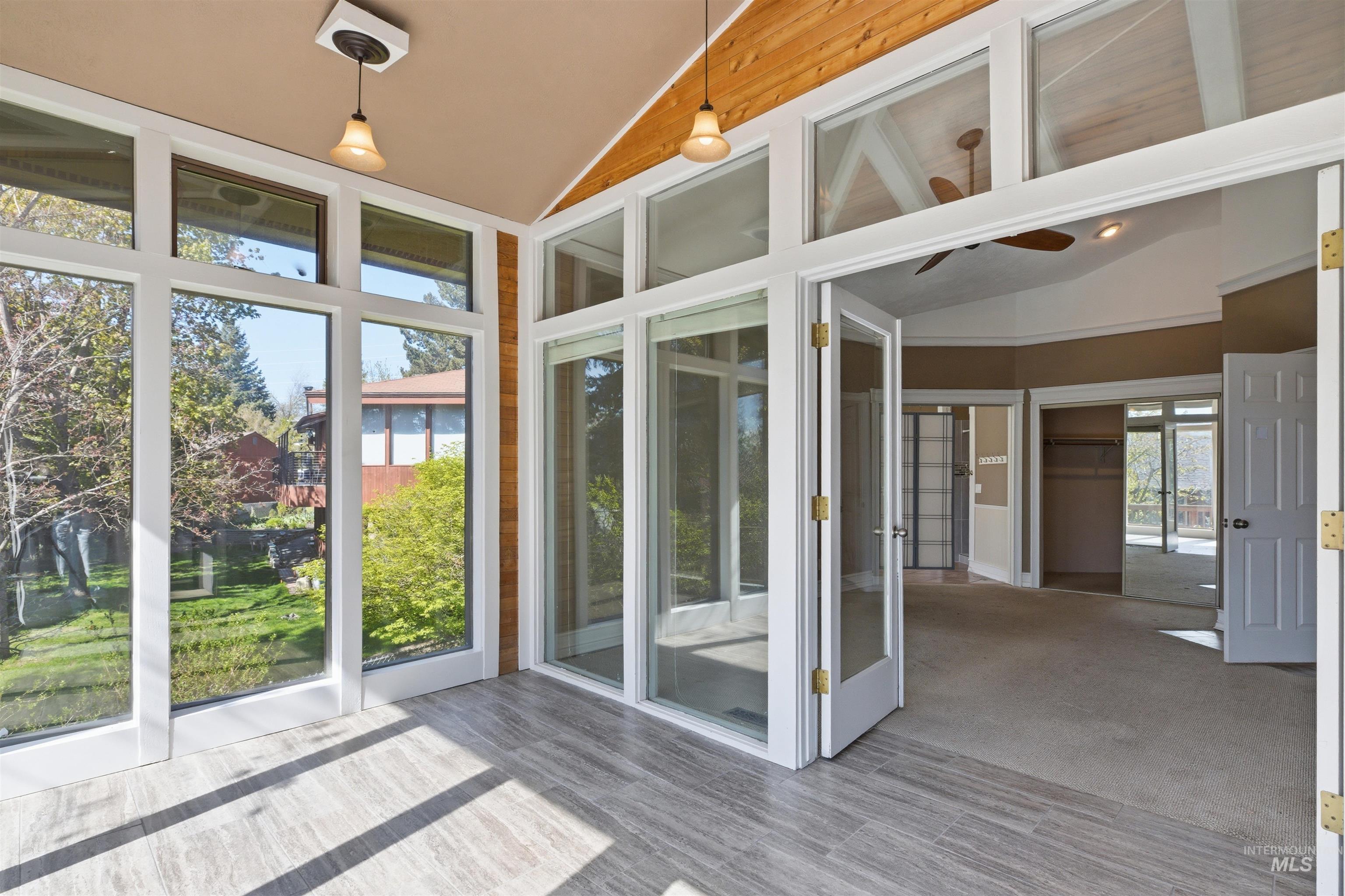 1540 Pine Cone Road Moscow, ID 83843 - Photo 15 of 49 Sunroom featuring large windows, wood-finish flooring, and a natural wood-plank ceiling