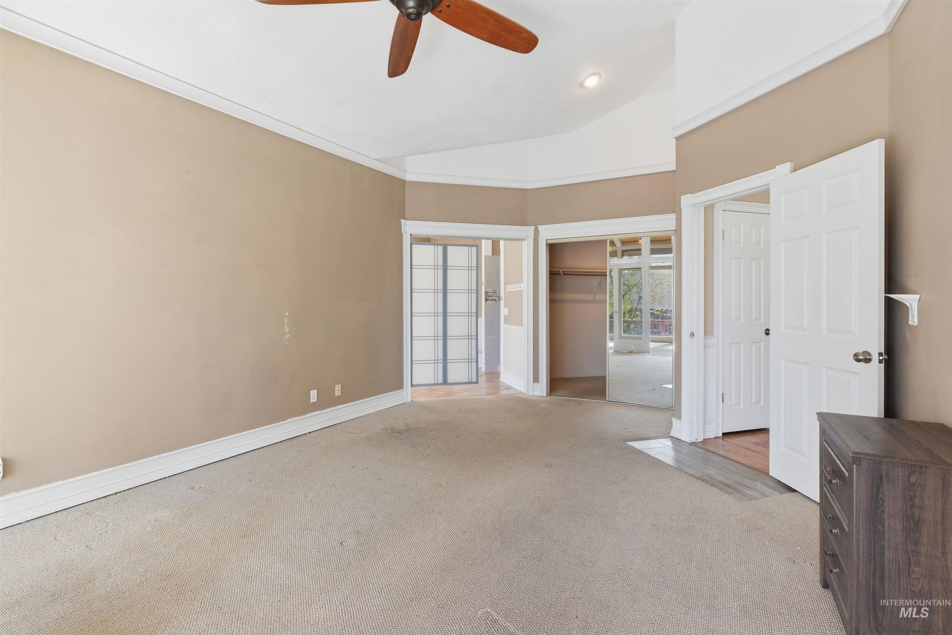 1540 Pine Cone Road Moscow, ID 83843 - Photo 16 of 49 Carpeted interior space featuring a ceiling fan, crown molding, and baseboards