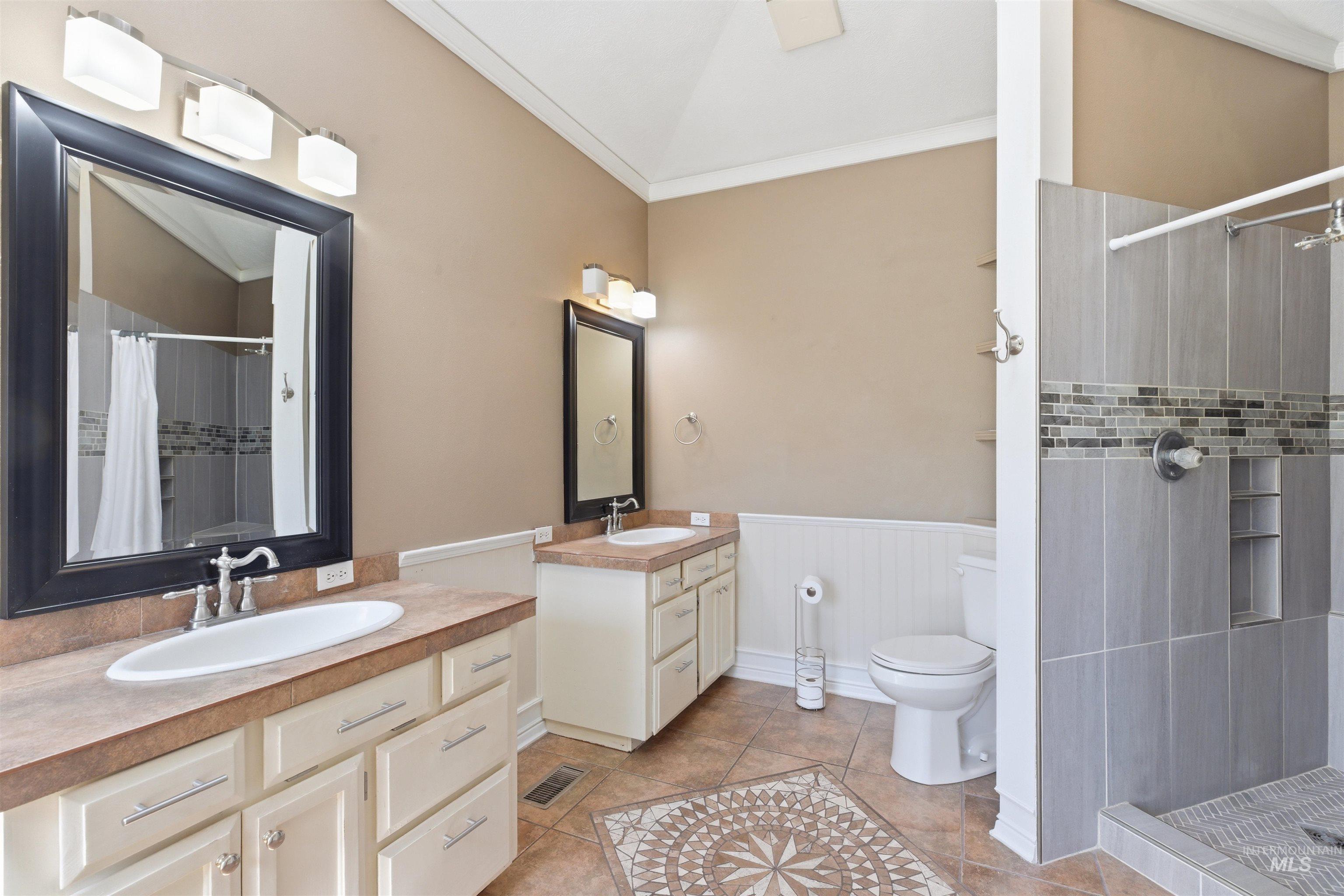 1540 Pine Cone Road Moscow, ID 83843 - Photo 18 of 49 Bathroom featuring a double vanity, tile flooring, and a walk-in shower with built-in shelving