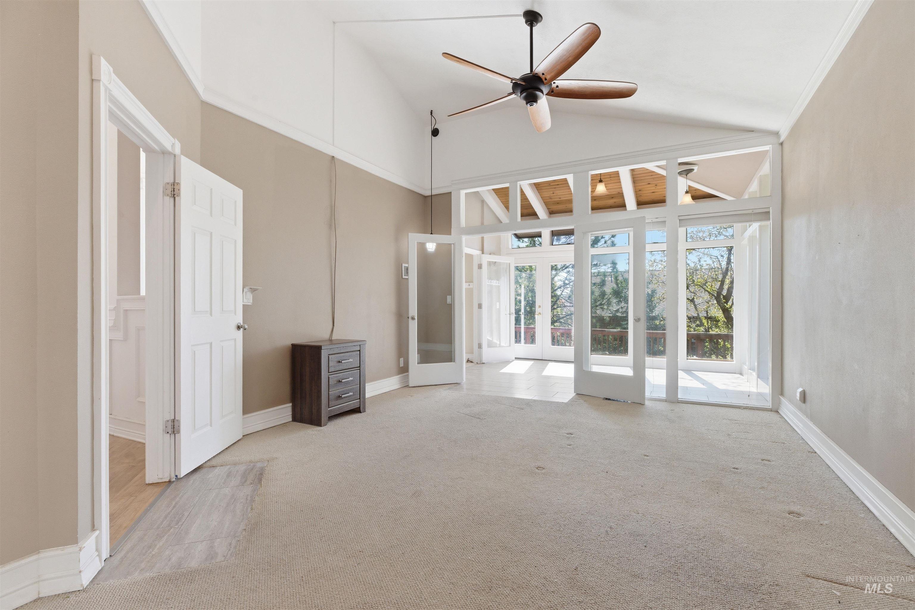 1540 Pine Cone Road Moscow, ID 83843 - Photo 21 of 49 Expansive room featuring a vaulted ceiling and a ceiling fan with wood-finish blades