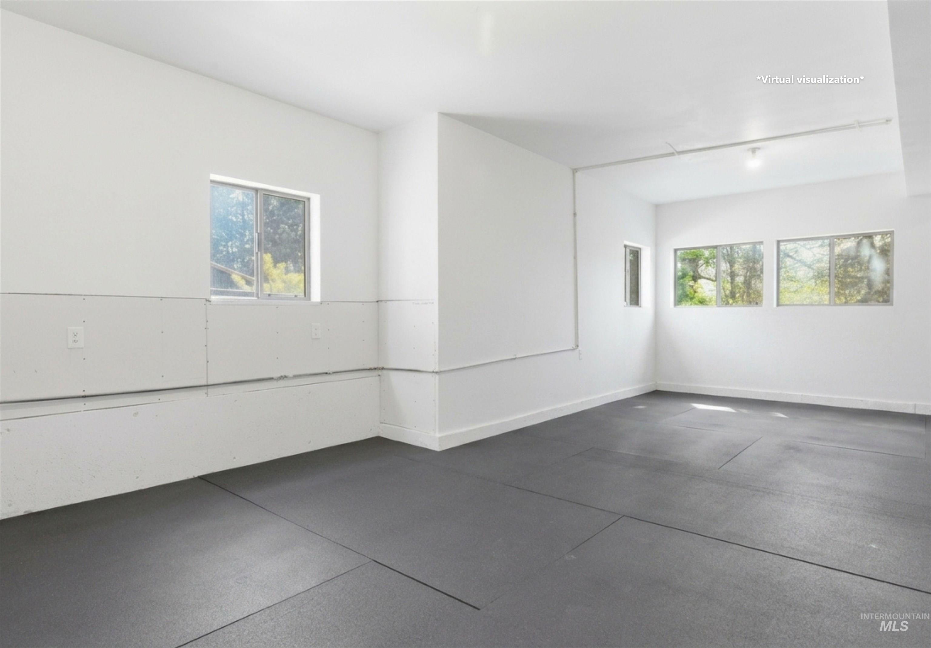 1540 Pine Cone Road Moscow, ID 83843 - Photo 26 of 49 Spacious room featuring four windows providing natural illumination, white painted walls, and dark-toned flooring