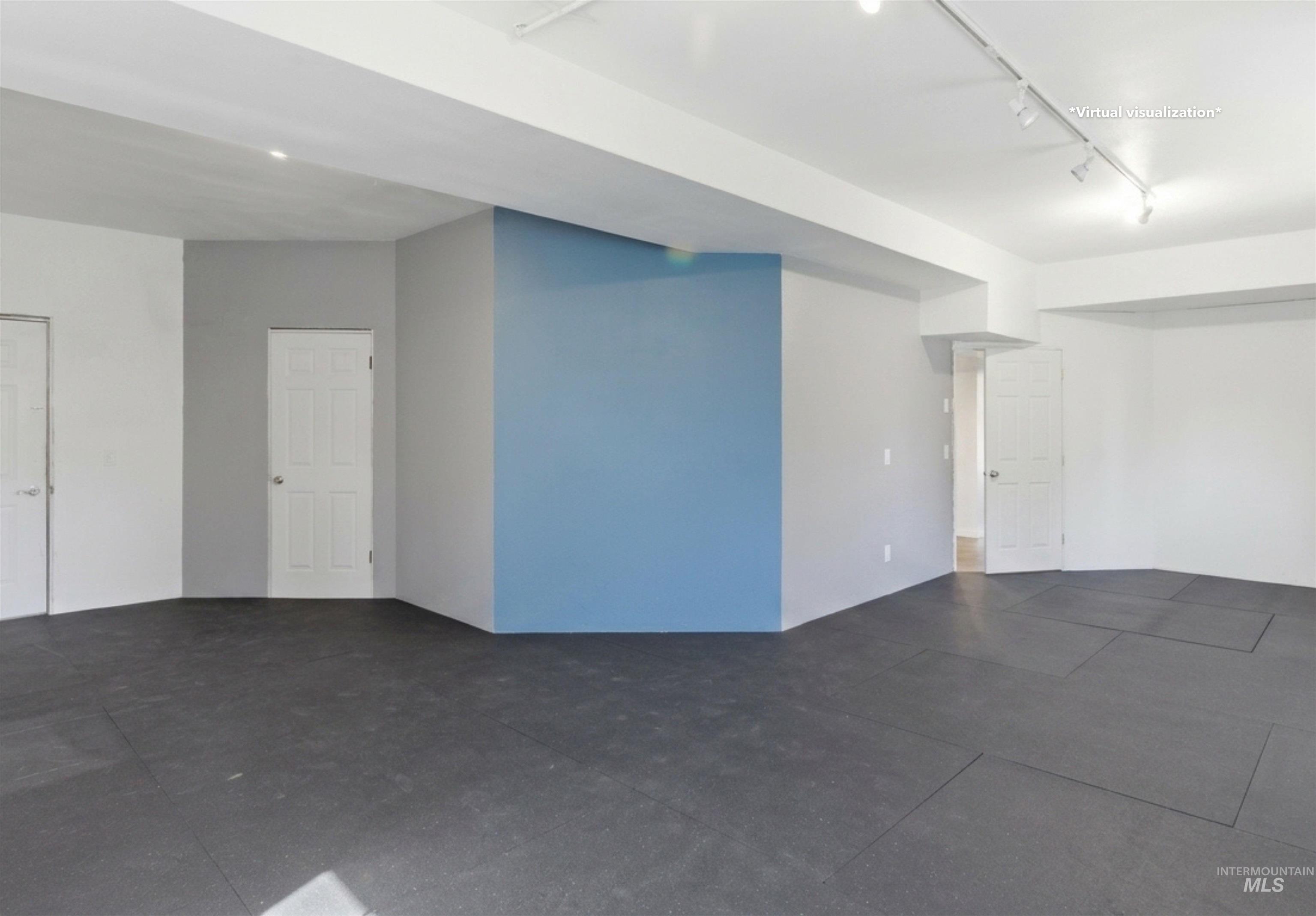 1540 Pine Cone Road Moscow, ID 83843 - Photo 28 of 49 Spacious interior featuring dark floor tiles, white walls, and a prominent blue accent wall