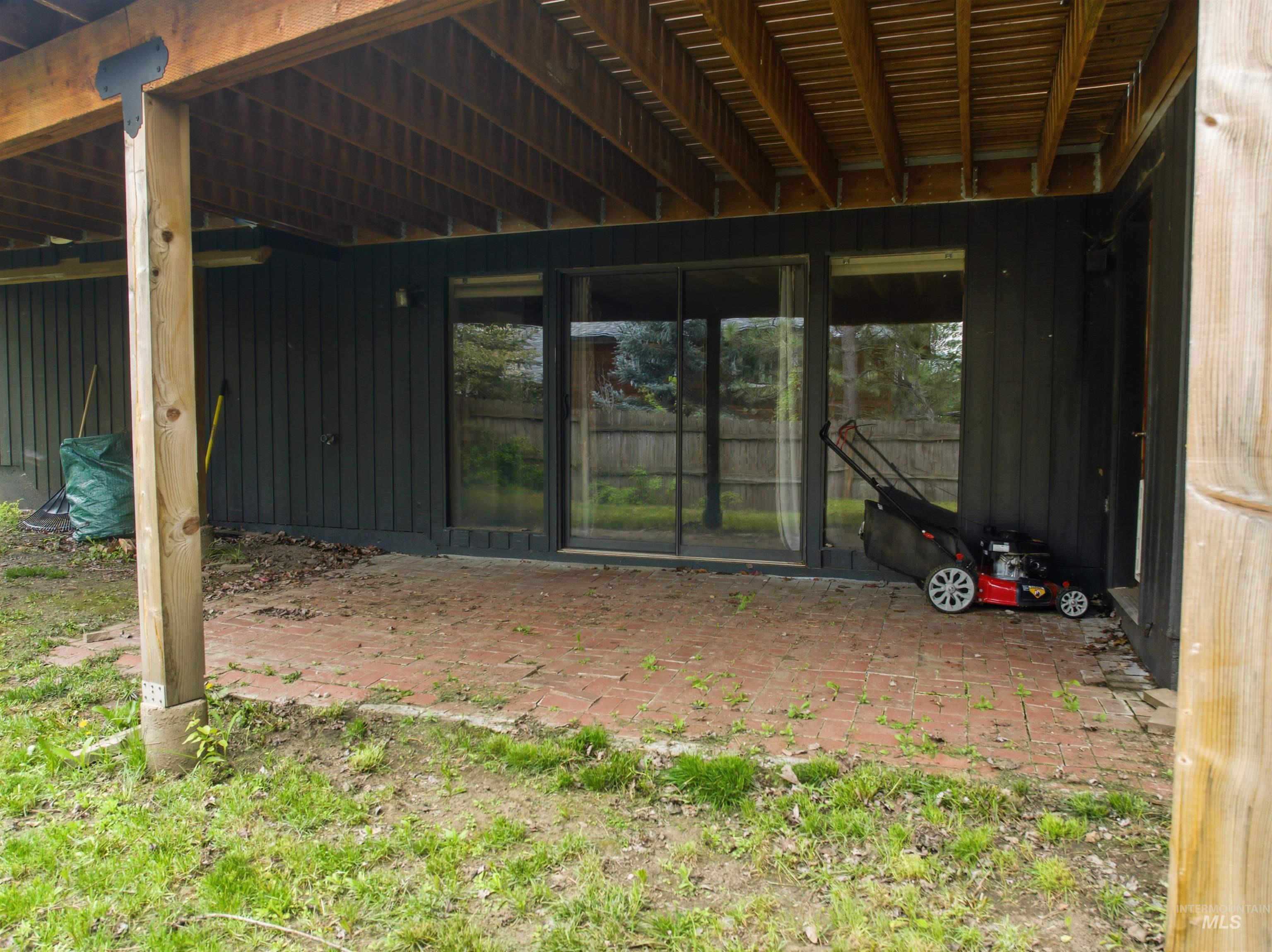 1540 Pine Cone Road Moscow, ID 83843 - Photo 42 of 49 Covered brick patio with exposed wood joist ceiling, supported by wood posts on concrete footings