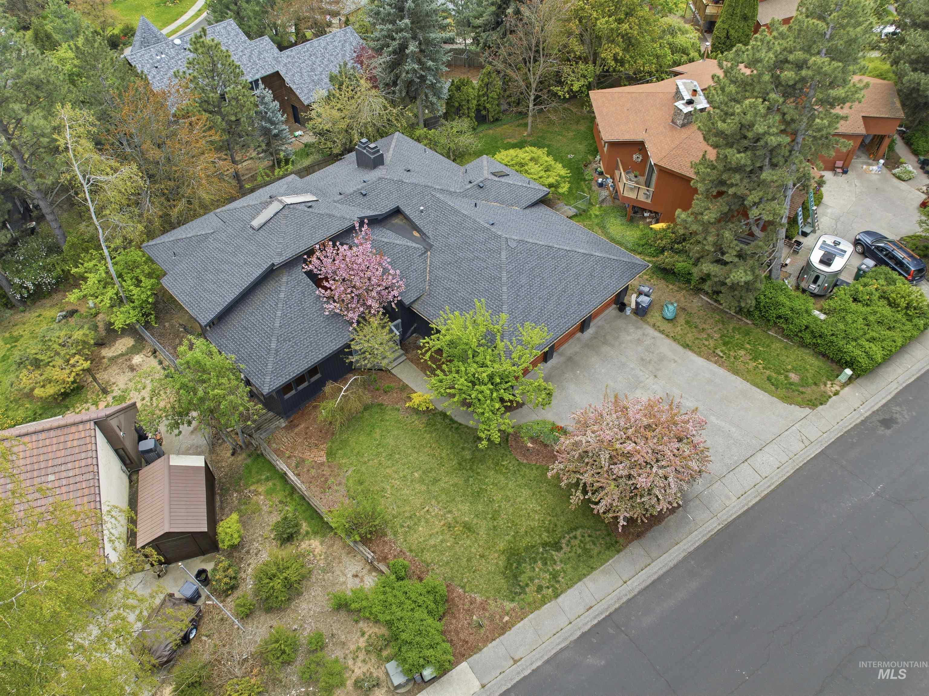1540 Pine Cone Road Moscow, ID 83843 - Photo 45 of 49 Multi-level residence featuring a dark shingle roof, attached two-car garage, and a concrete driveway