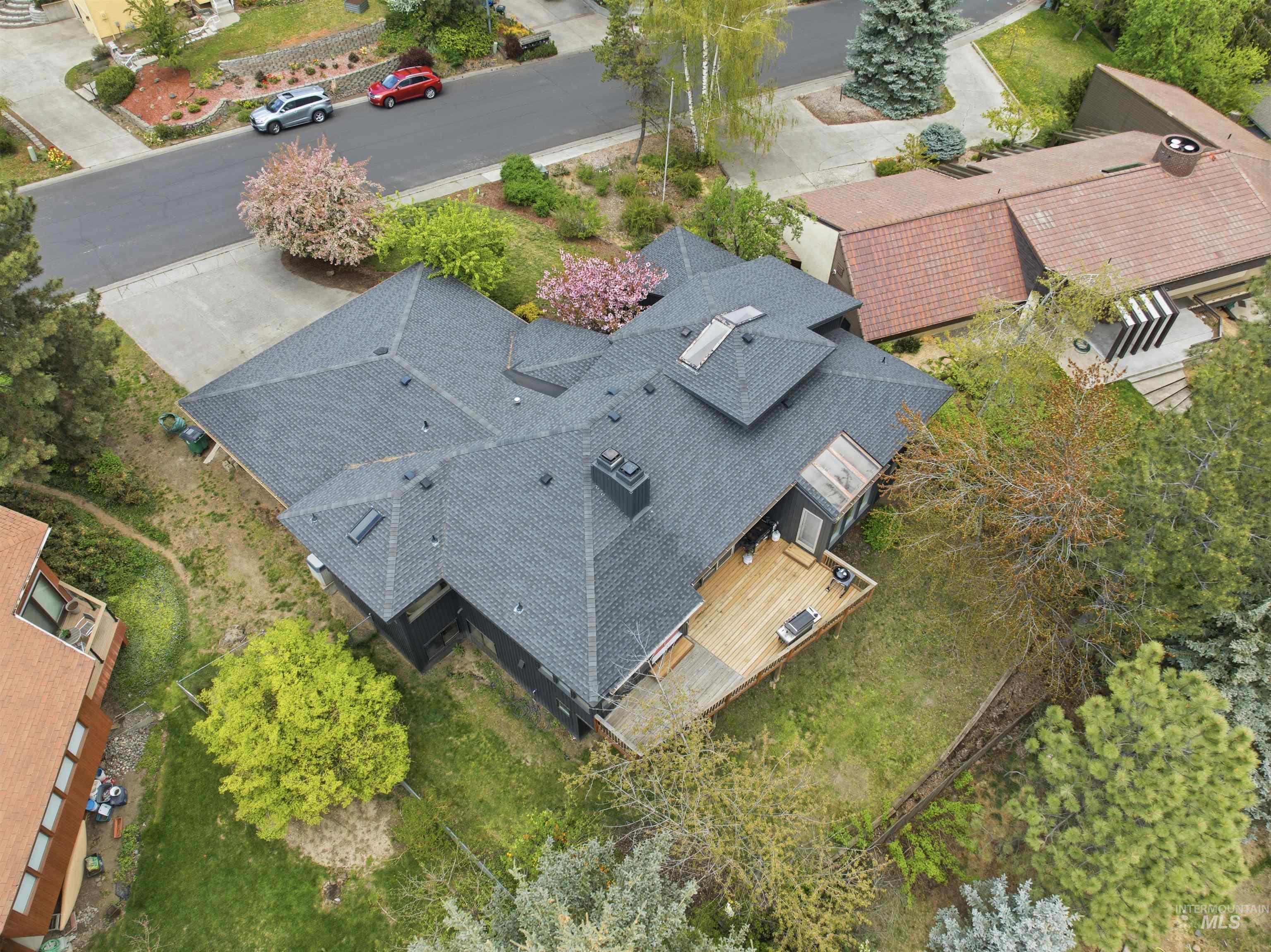 1540 Pine Cone Road Moscow, ID 83843 - Photo 47 of 49 Multi-level asphalt shingle roofline with multiple skylights and a prominent chimney
