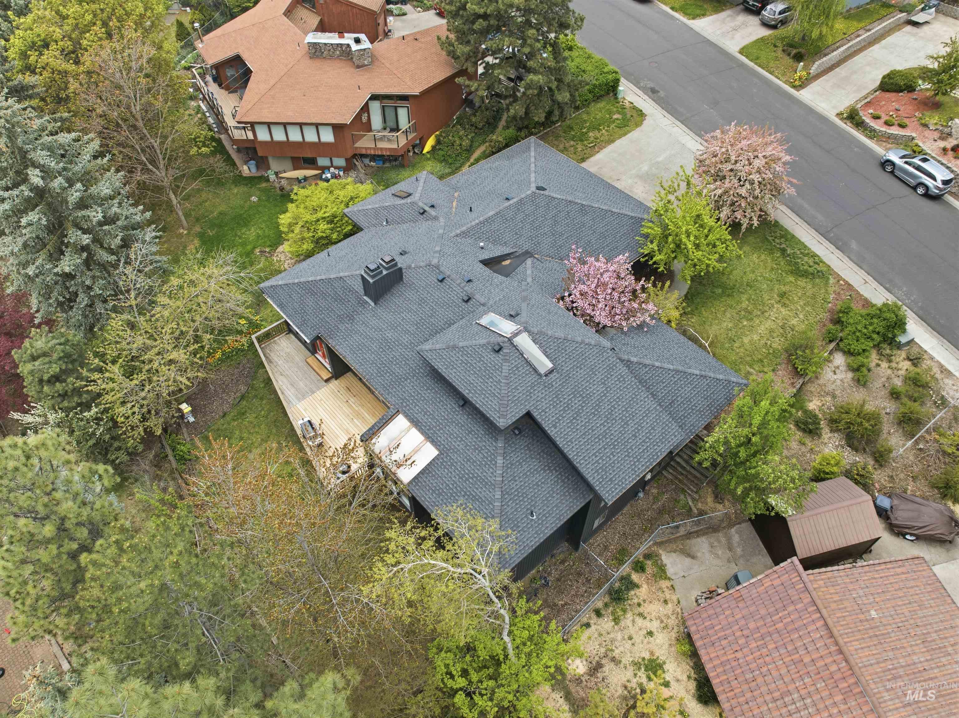 1540 Pine Cone Road Moscow, ID 83843 - Photo 48 of 49 Contemporary residence with a multi-level dark gray shingle roof, integrated skylights, and a prominent chimney