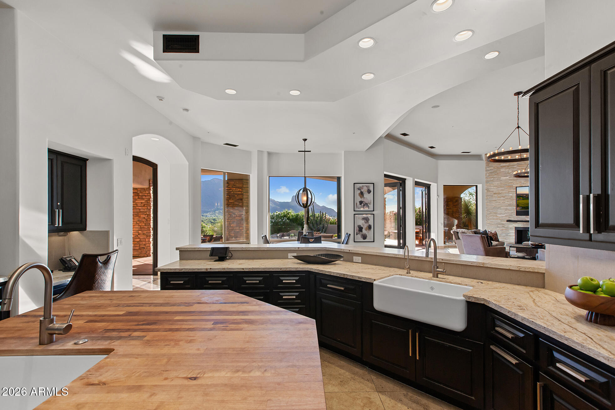 6207 East Indian Bend Road Paradise Valley, AZ 85253 - Photo 14 of 42 a large kitchen with kitchen island a sink stainless steel appliances and cabinets