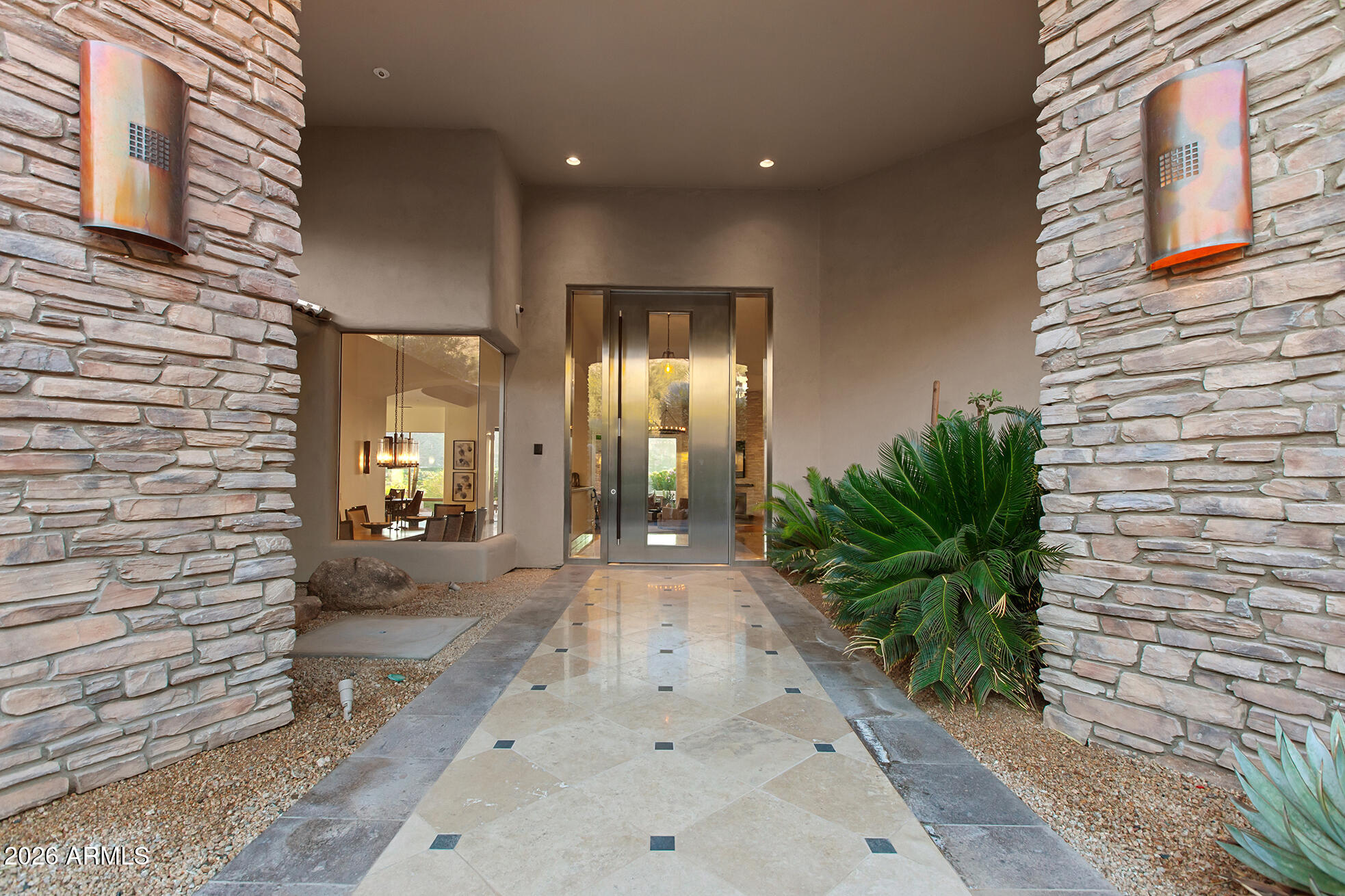 6207 East Indian Bend Road Paradise Valley, AZ 85253 - Photo 37 of 42 a view of a hallway with potted plants