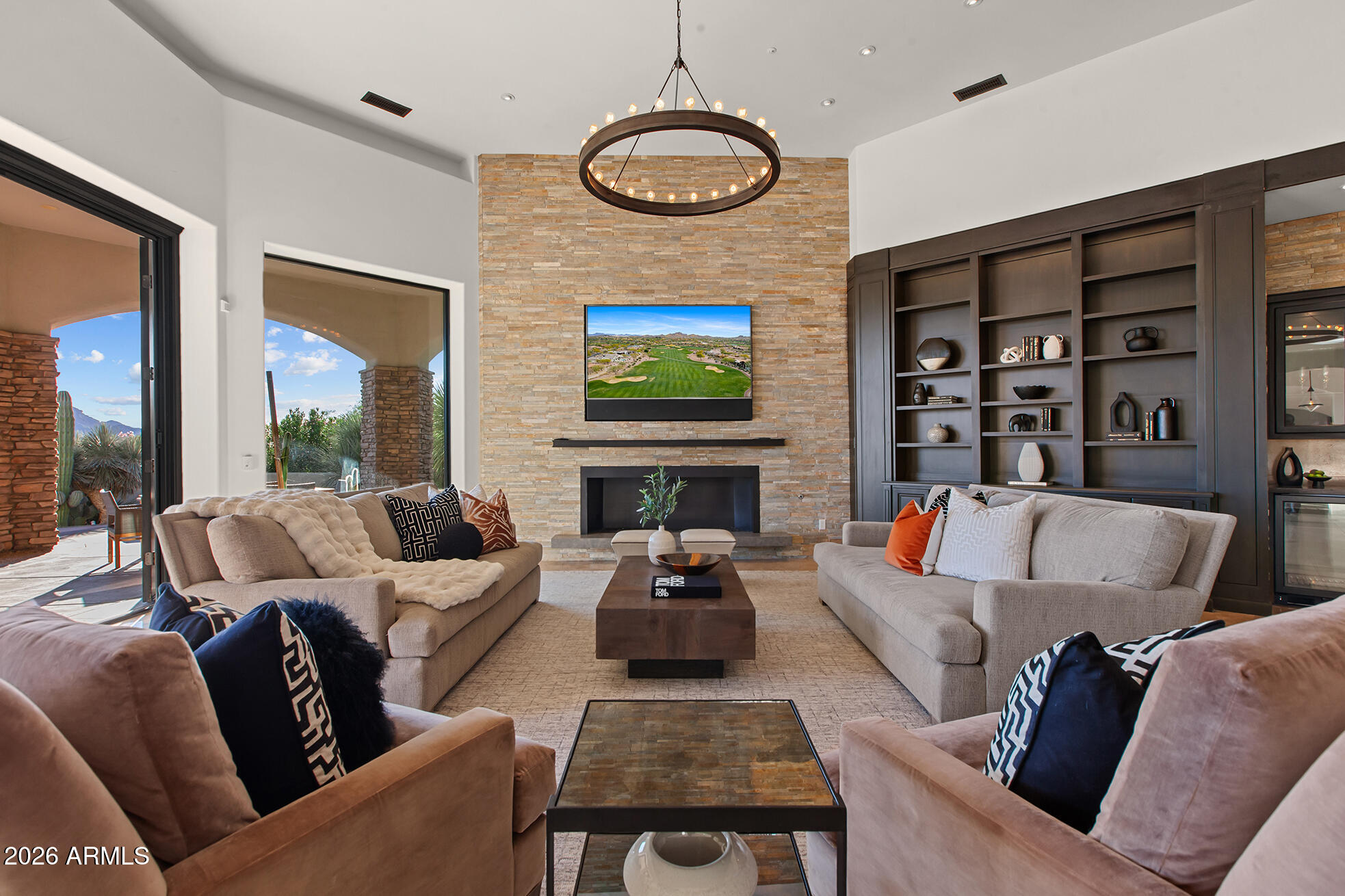6207 East Indian Bend Road Paradise Valley, AZ 85253 - Photo 8 of 42 a living room with furniture a fireplace and a flat screen tv