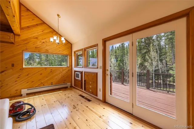 a view of a living room with wooden floor and windows