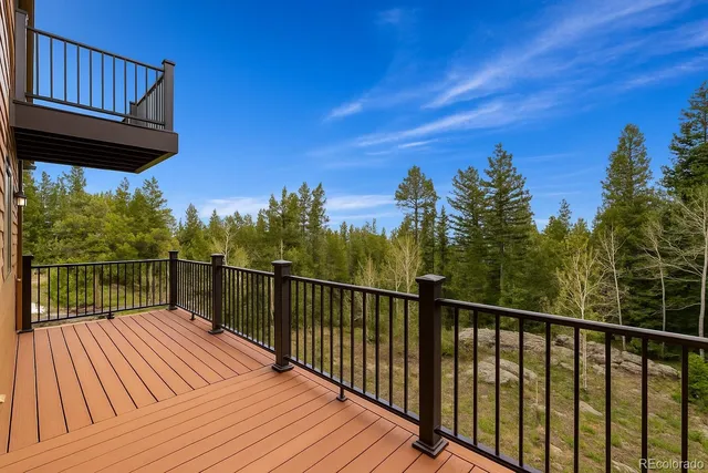 a view of balcony with wooden floor and fence