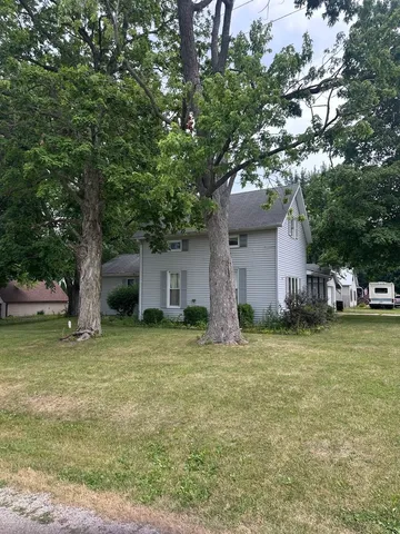 a house that has a tree in front of it