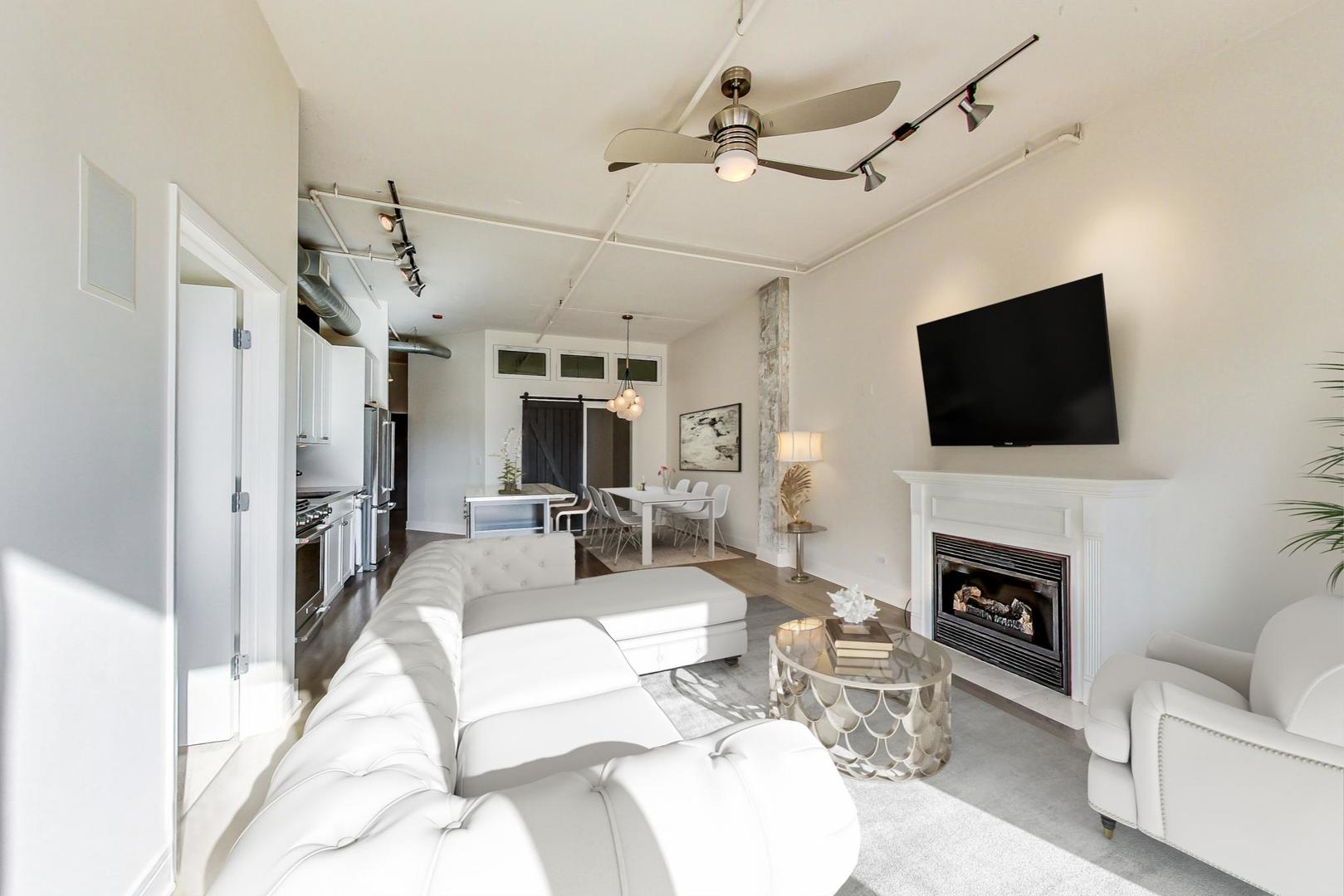 950 West Monroe Street, Unit 608 Chicago, IL 60607 - Photo 12 of 44 a living room with furniture a fireplace and a flat screen tv