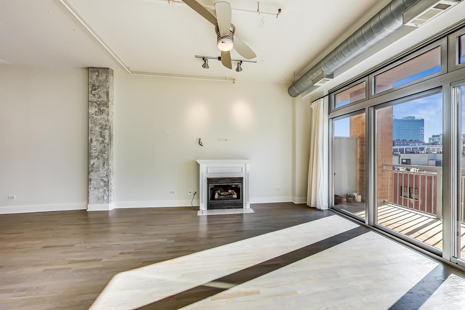950 West Monroe Street, Unit 608 Chicago, IL 60607 - Photo 13 of 44 a view of a livingroom with wooden floor and a fireplace