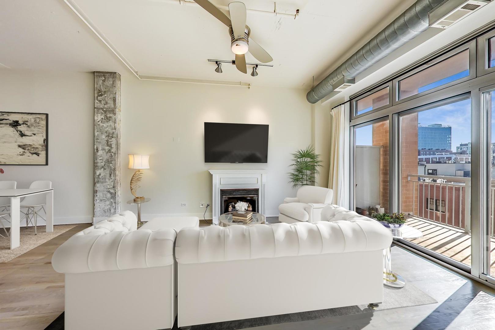 950 West Monroe Street, Unit 608 Chicago, IL 60607 - Photo 14 of 44 a living room with fireplace furniture and a flat screen tv