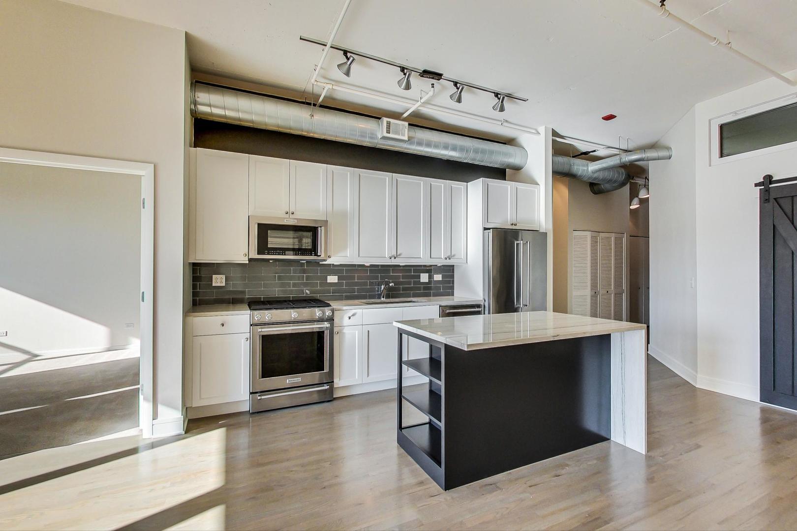 950 West Monroe Street, Unit 608 Chicago, IL 60607 - Photo 18 of 44 a kitchen with a stove and a microwave
