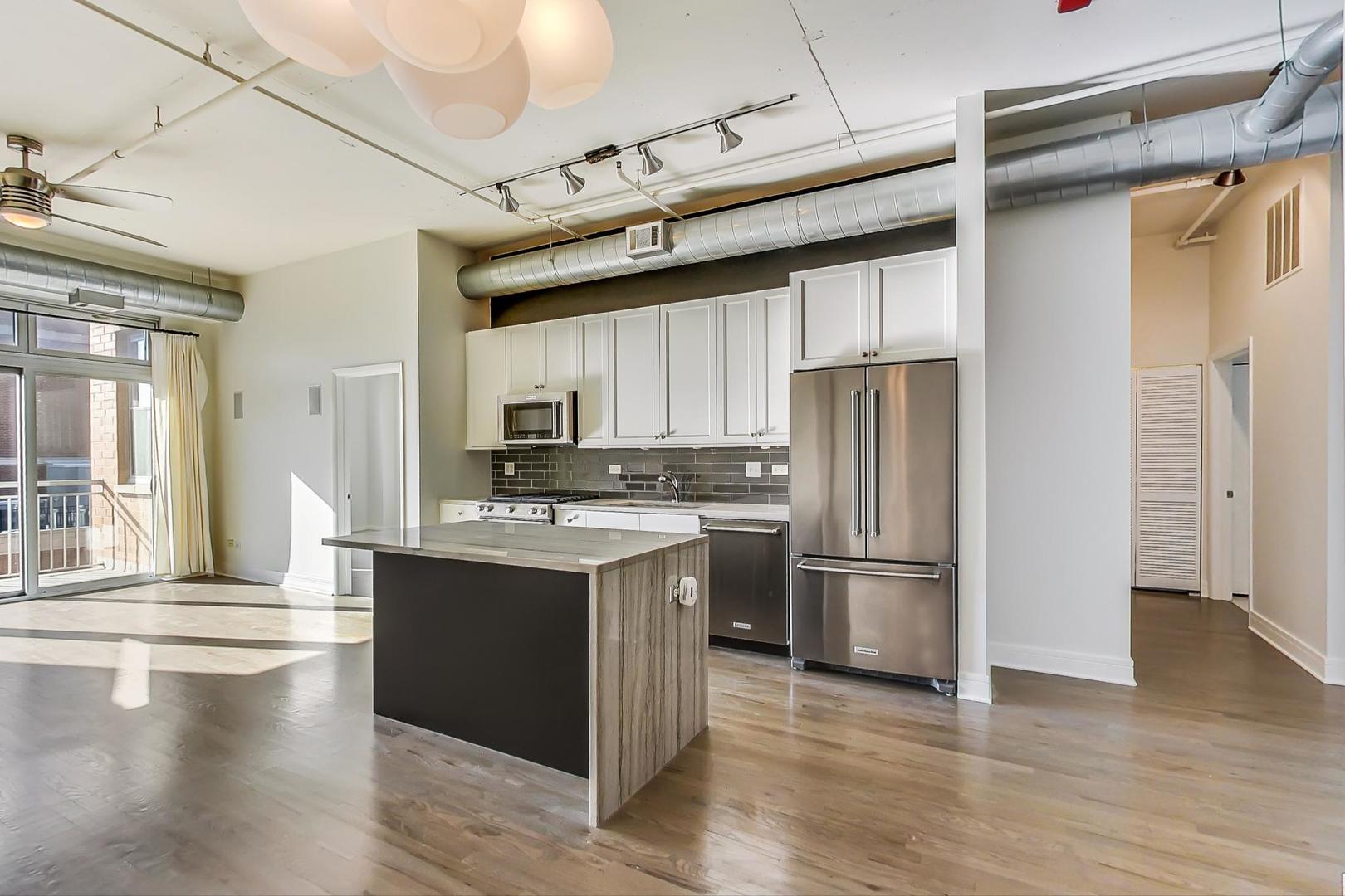 950 West Monroe Street, Unit 608 Chicago, IL 60607 - Photo 19 of 44 a kitchen with stainless steel appliances granite countertop a refrigerator and a stove