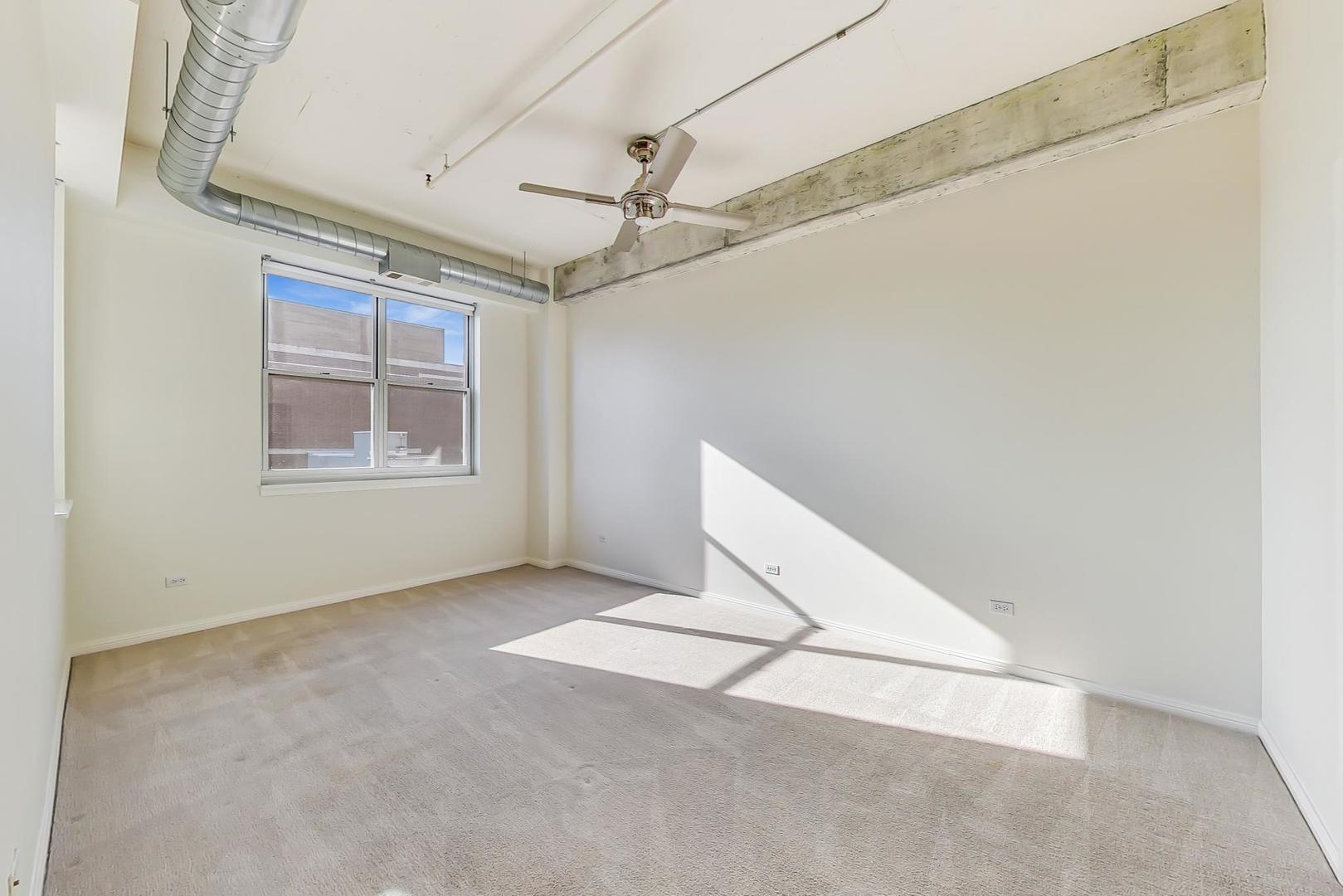 950 West Monroe Street, Unit 608 Chicago, IL 60607 - Photo 21 of 44 an empty room with windows and fan
