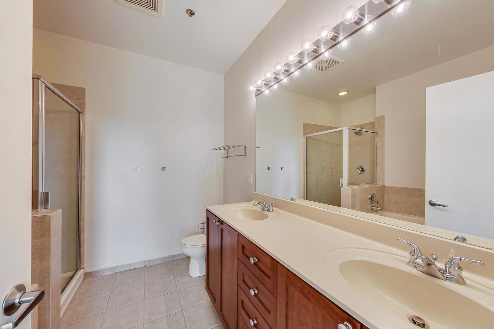 950 West Monroe Street, Unit 608 Chicago, IL 60607 - Photo 26 of 44 a spacious bathroom with a double vanity sink mirror and toilet