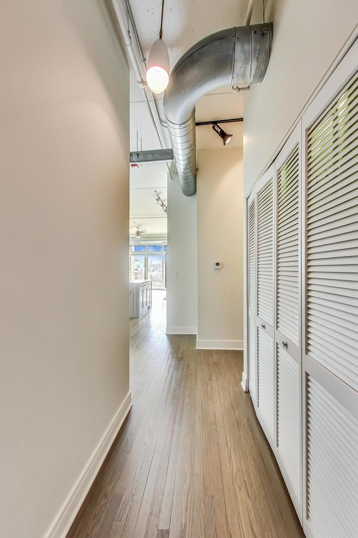 950 West Monroe Street, Unit 608 Chicago, IL 60607 - Photo 9 of 44 a view of a hallway with wooden floor