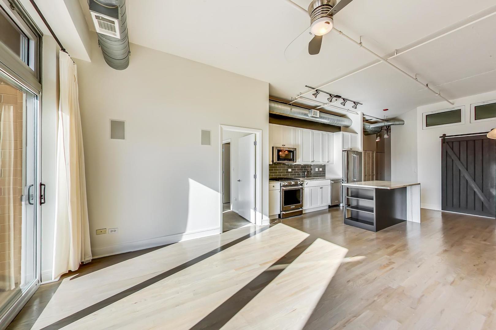 950 West Monroe Street, Unit 608 Chicago, IL 60607 - Photo 10 of 44 a living room with stainless steel appliances furniture a kitchen view and a refrigerator