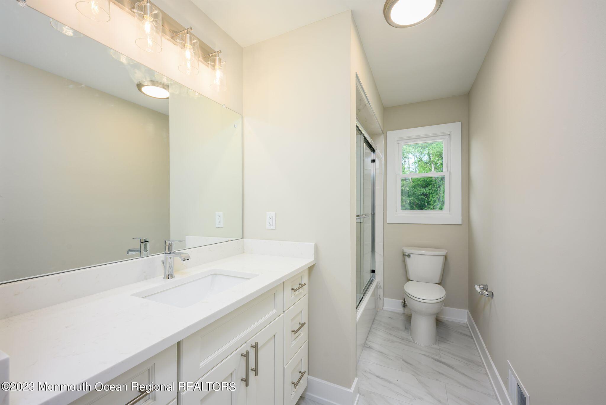 117 Lemon Road Howell, NJ 07731 - Photo 20 of 31 a bathroom with a sink a toilet and a mirror