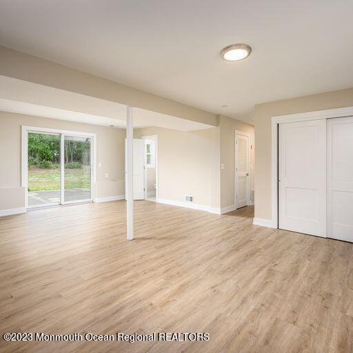 117 Lemon Road Howell, NJ 07731 - Photo 23 of 31 an empty room with wooden floor and natural light