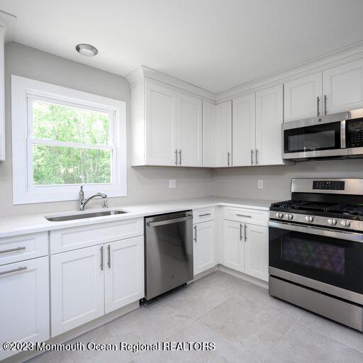 117 Lemon Road Howell, NJ 07731 - Photo 5 of 31 a kitchen with stainless steel appliances granite countertop a sink a stove a microwave and cabinets