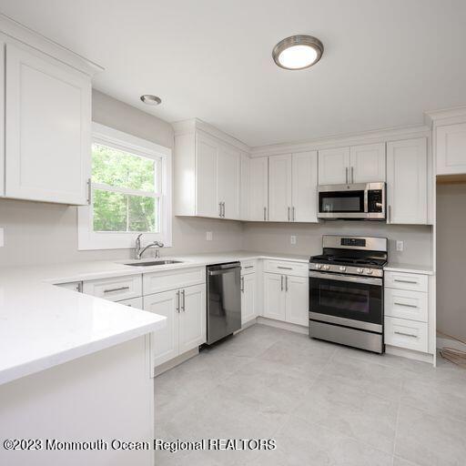 117 Lemon Road Howell, NJ 07731 - Photo 6 of 31 a kitchen with a stove a sink and a window