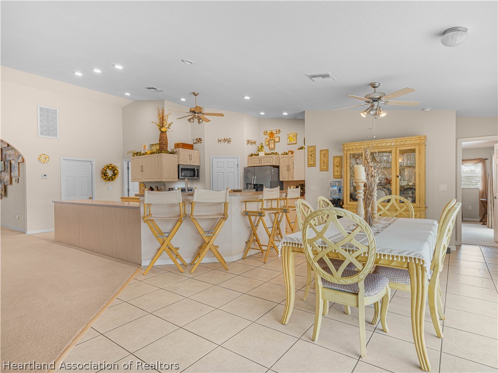 5721 Golden Road Sebring, FL 33875 - Photo 10 of 42 Spacious Breakfast Nook and Breakfast Bar. Breakfast nook accesses pool and lanai via sliding glass doors.