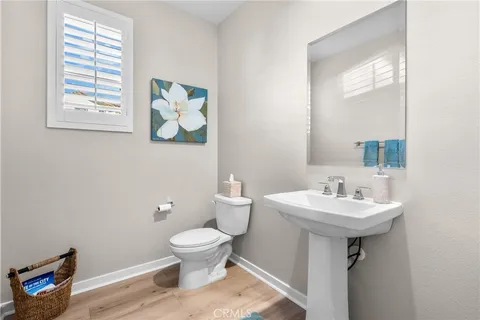 a bathroom with a sink toilet and a mirror