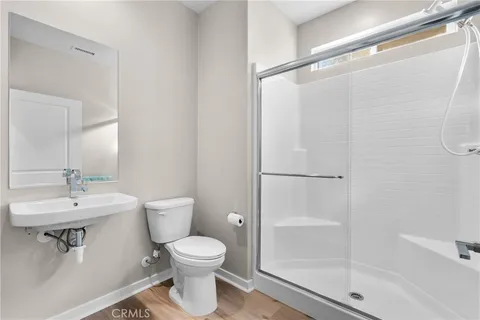 a bathroom with a toilet a sink and shower