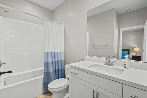 a kitchen with a stove sink and cabinets