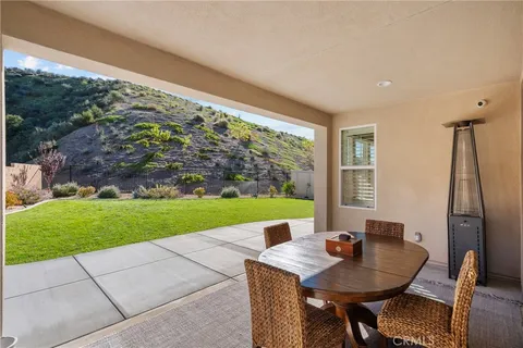 a view of a chairs and table in the patio