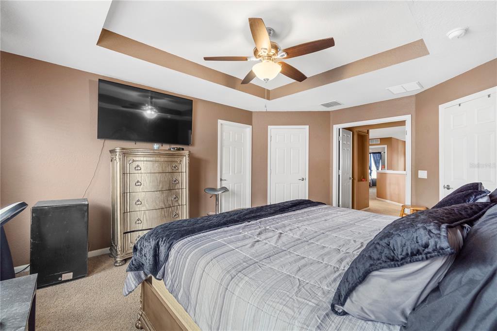 4199 Southwest 46th Court Ocala, FL 34474 - Photo 27 of 50 a bedroom with a bed and a flat screen tv