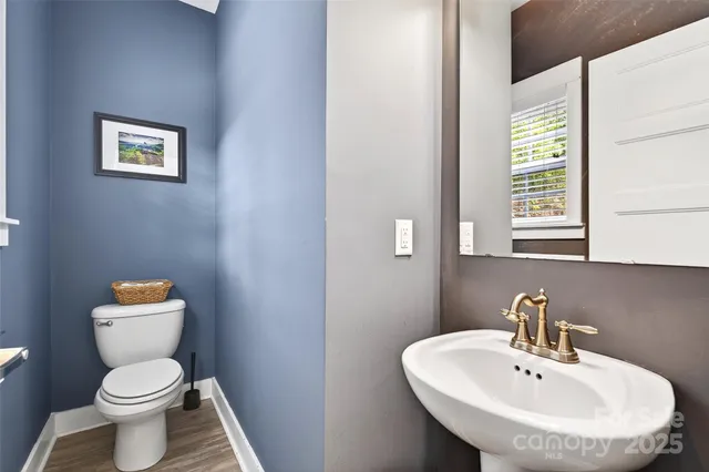 a white toilet sitting next to a bathroom sink