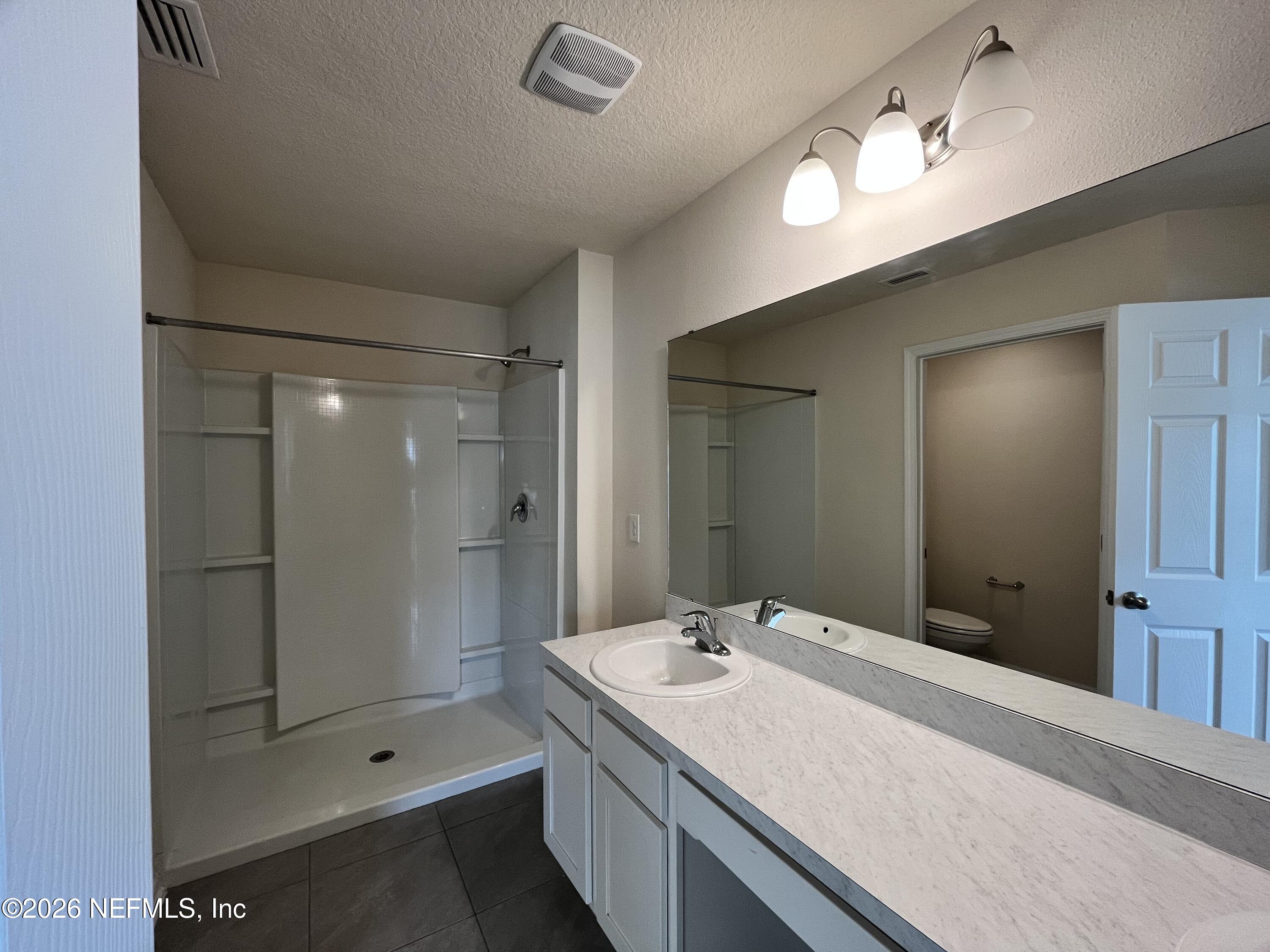 548 Coastline Way St. Augustine, FL 32092 - Photo 15 of 21 a bathroom with a shower sink and mirror
