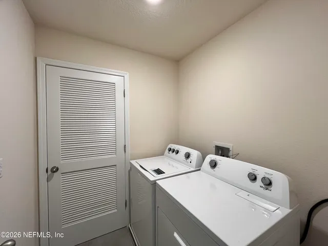 a utility room with dryer and washer