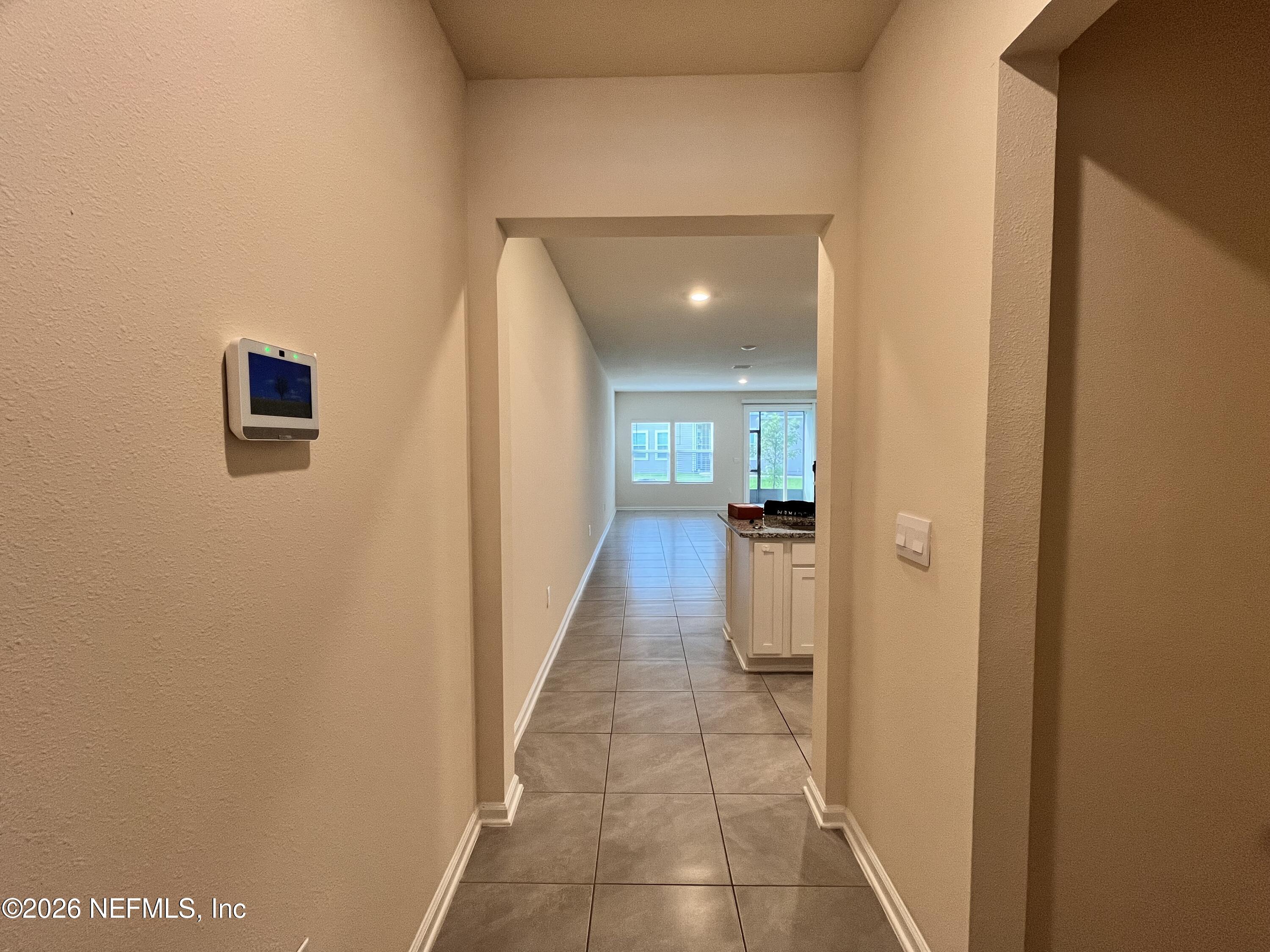 548 Coastline Way St. Augustine, FL 32092 - Photo 3 of 21 a view of a hallway with a furniture and a living room