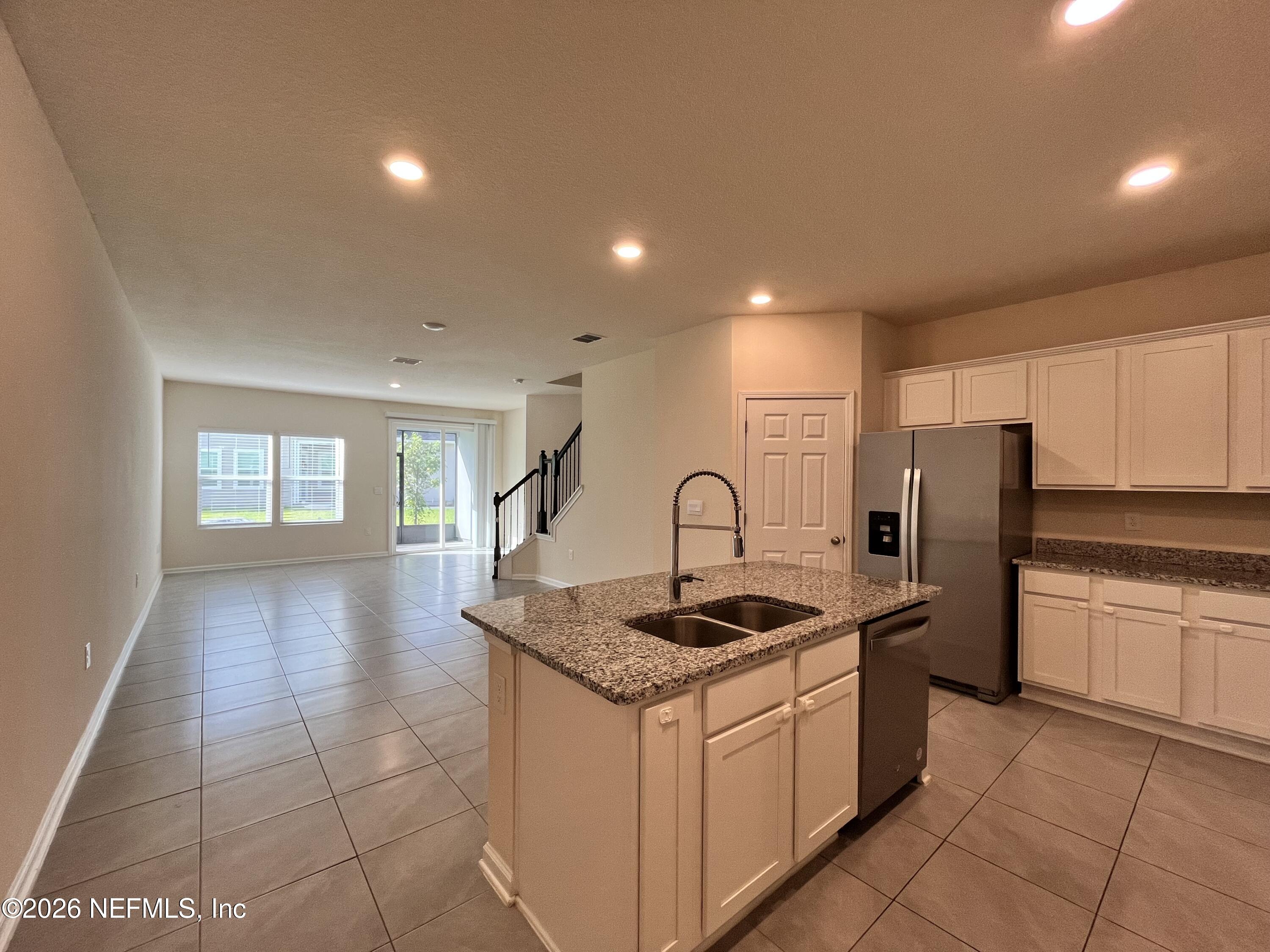 548 Coastline Way St. Augustine, FL 32092 - Photo 5 of 21 a kitchen with stainless steel appliances granite countertop a sink stove and refrigerator