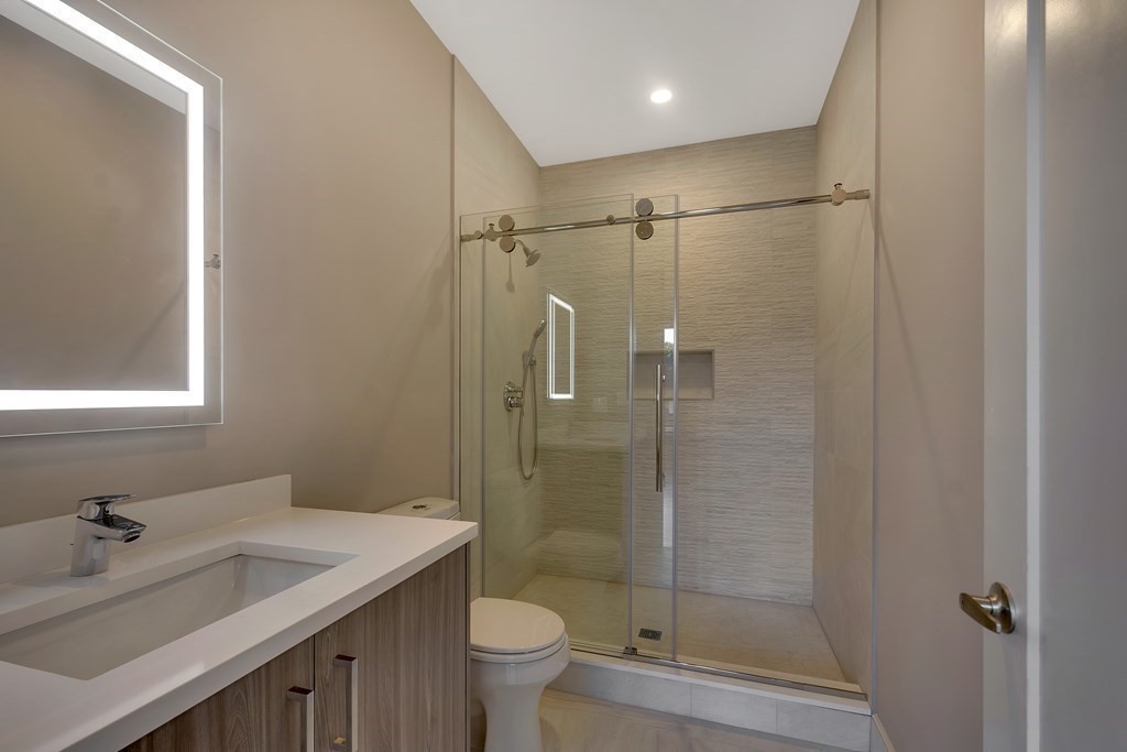 50 Gould Road Newton, MA 02468 - Photo 11 of 12 a bathroom with a shower sink vanity mirror and toilet