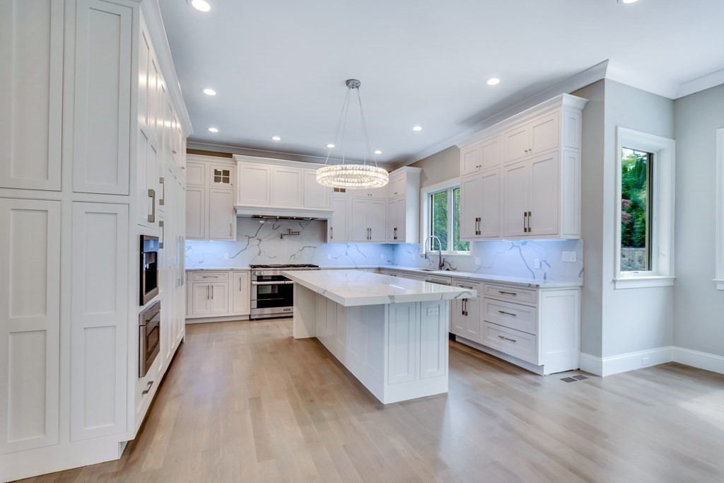 50 Gould Road Newton, MA 02468 - Photo 9 of 12 a large kitchen with stainless steel appliances kitchen island a large counter top and a stove top oven