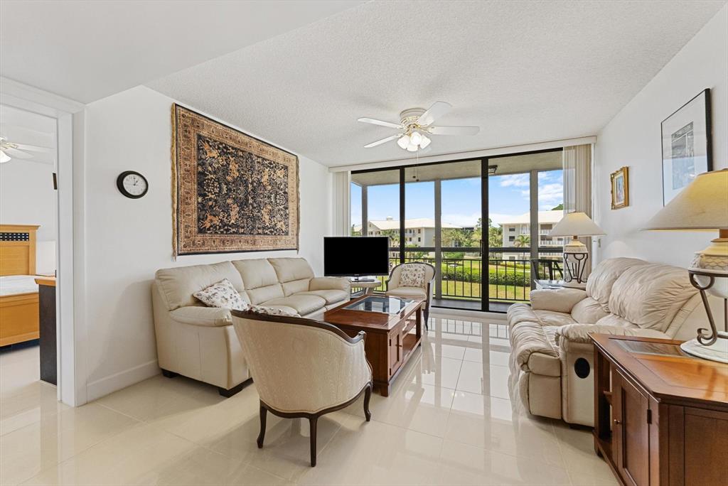 6217 Balboa Circle, Unit 305 Boca Raton, FL 33433 - Photo 11 of 28 a living room with furniture and a flat screen tv