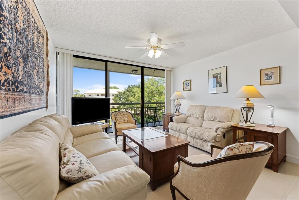 6217 Balboa Circle, Unit 305 Boca Raton, FL 33433 - Photo 12 of 28 a living room with furniture and a large window