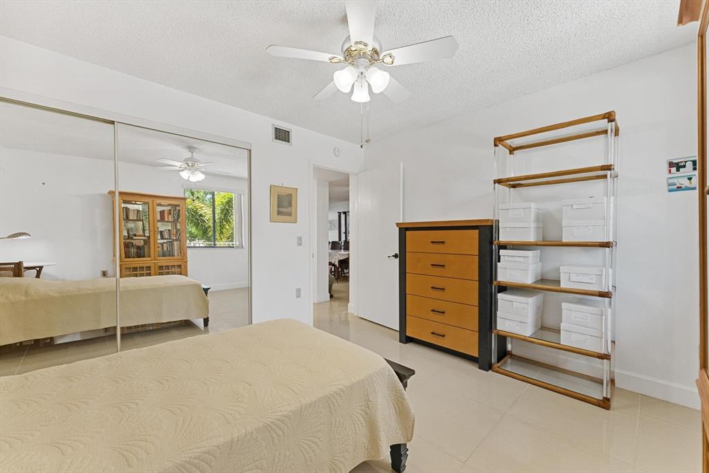 6217 Balboa Circle, Unit 305 Boca Raton, FL 33433 - Photo 19 of 28 a bedroom with a bed and furniture