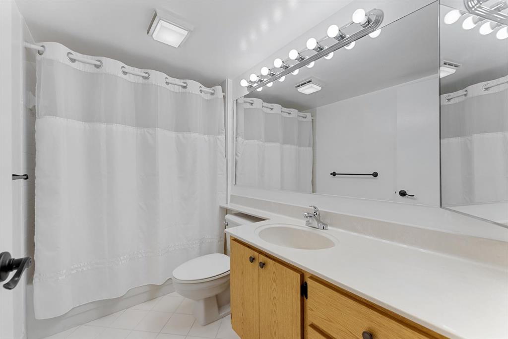 6217 Balboa Circle, Unit 305 Boca Raton, FL 33433 - Photo 20 of 28 a bathroom with a sink toilet a mirror and shower